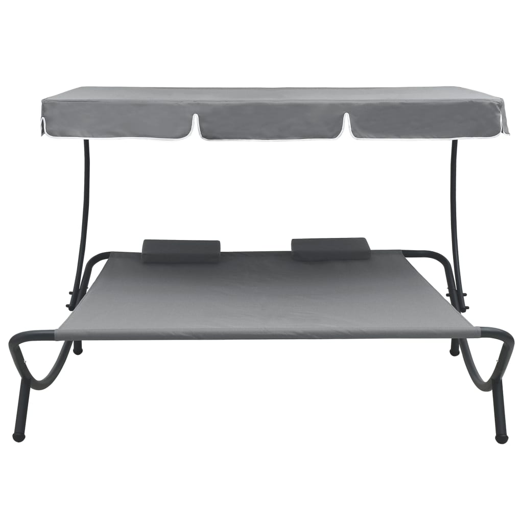 Outdoor rest bed with awning and gray pillows