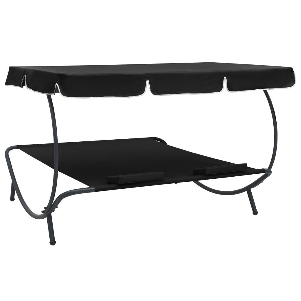Outdoor rest bed with black awning and pillows