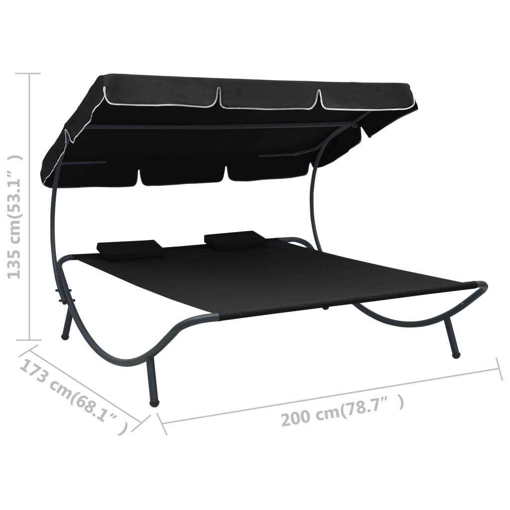 Outdoor rest bed with black awning and pillows