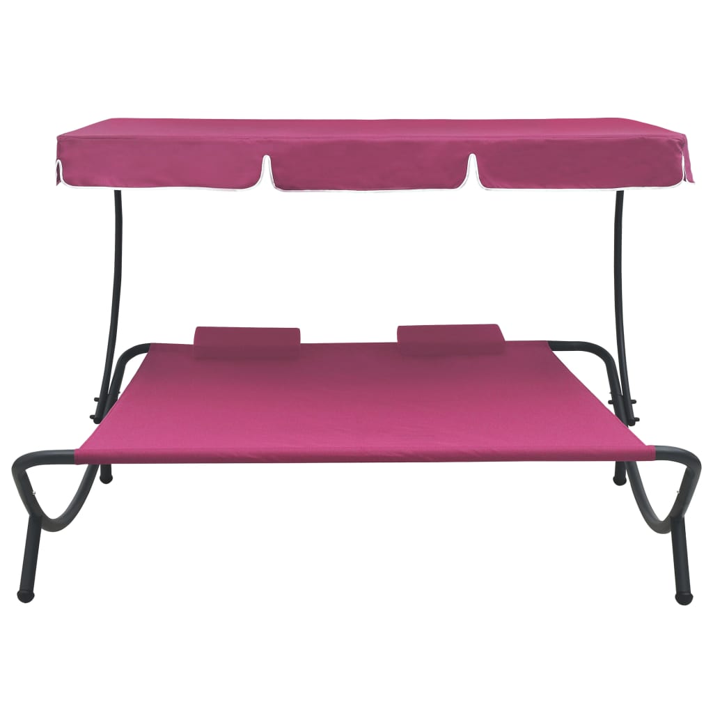 Outdoor rest bed with pink awning and pillows